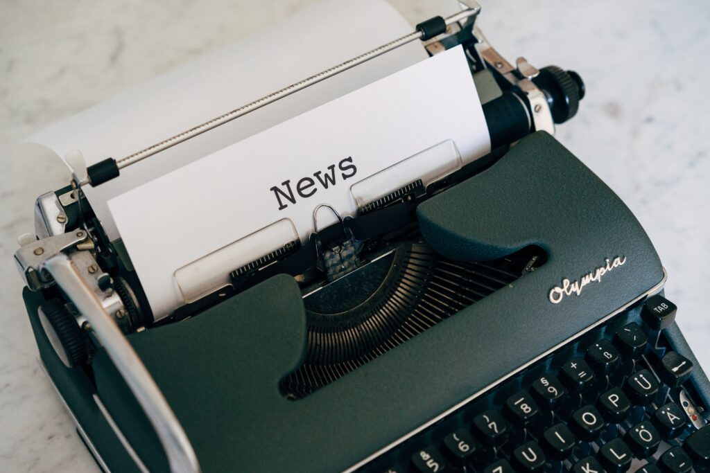 A typewriter with the word news on it.